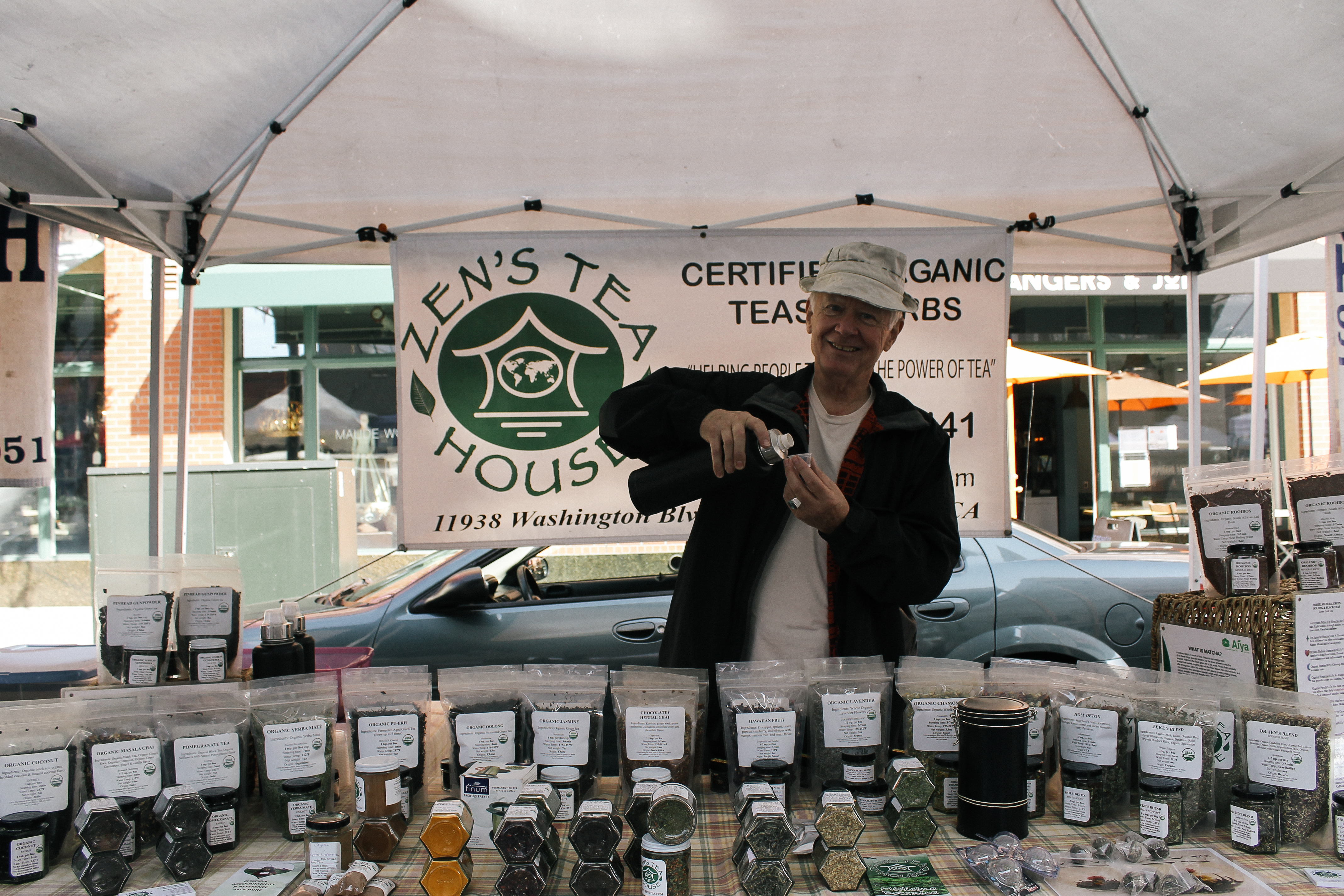 owner of Zen's Tea House pouring a samples for shoppers
