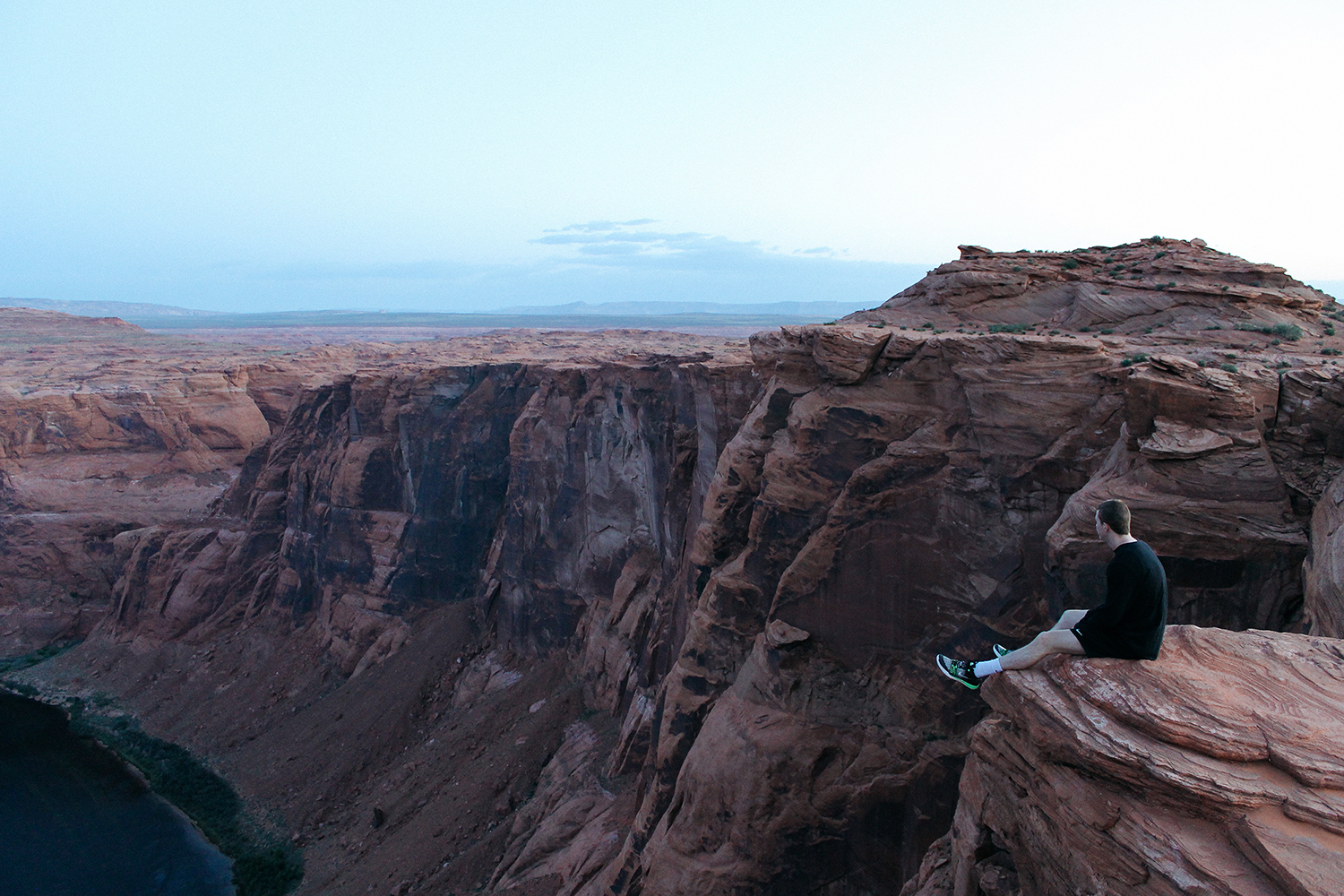 A person sitting at Horseshoe Bend.
