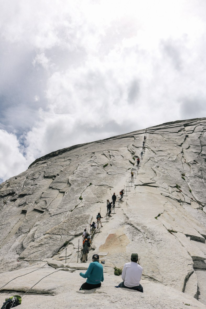 watching brave hikers climb up from the bottom of Half Dome
