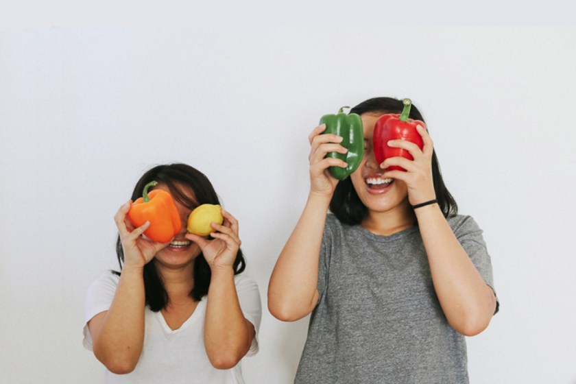 Vivian and Jennifer holding vegetables