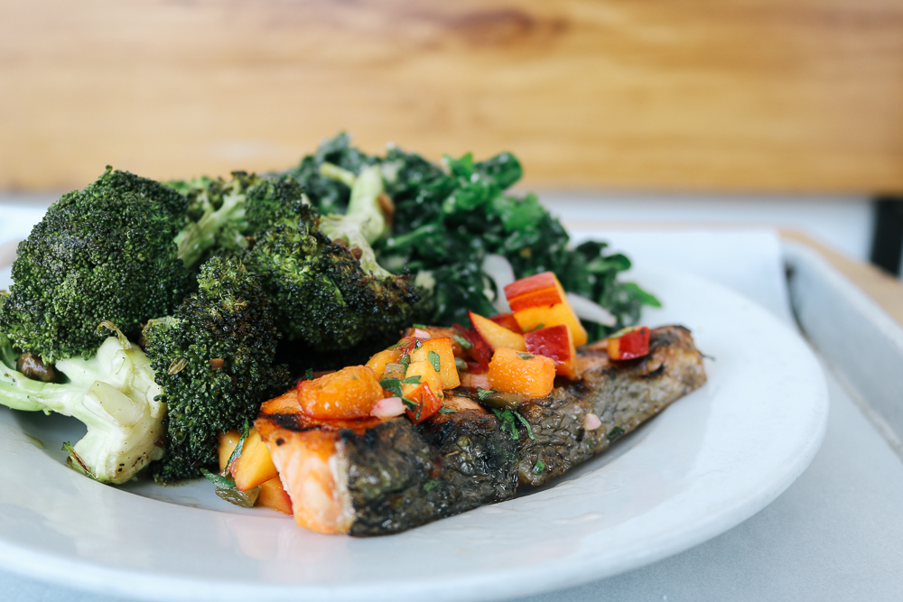 Fresh grilled salmon, kale salad, and roasted broccoli