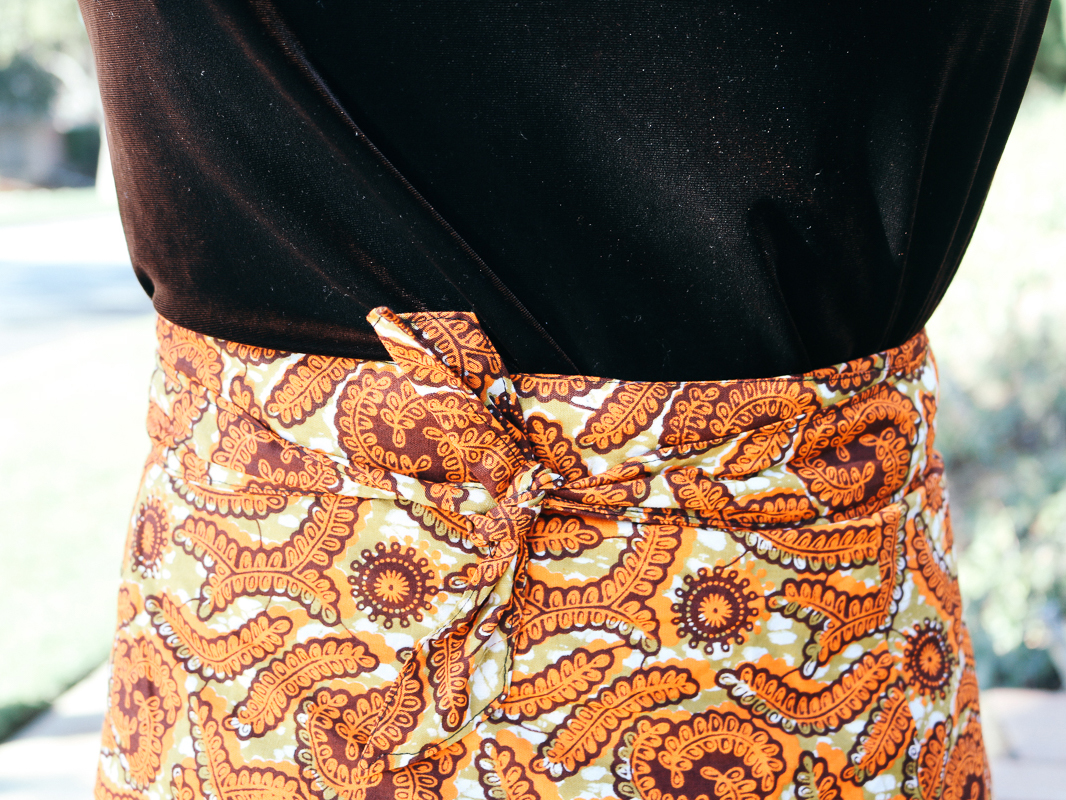 Vivian in a velvet top and knee length wrap skirt.