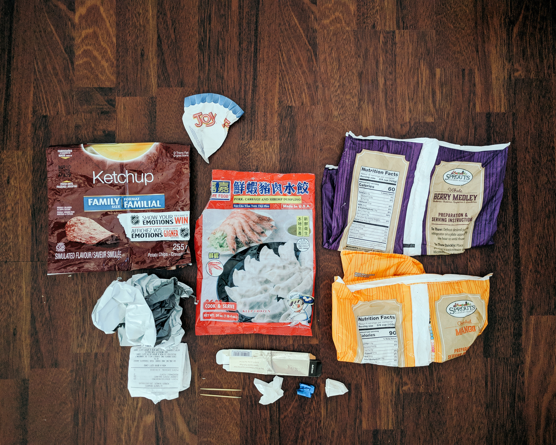 Packaging from Lay’s Ketchup chips, clothes from online, receipts, wax-lined paper from an ice cream cone, Asian dumplings, eyeliner, toothpicks, sample cup, gum wrappers, and frozen fruits