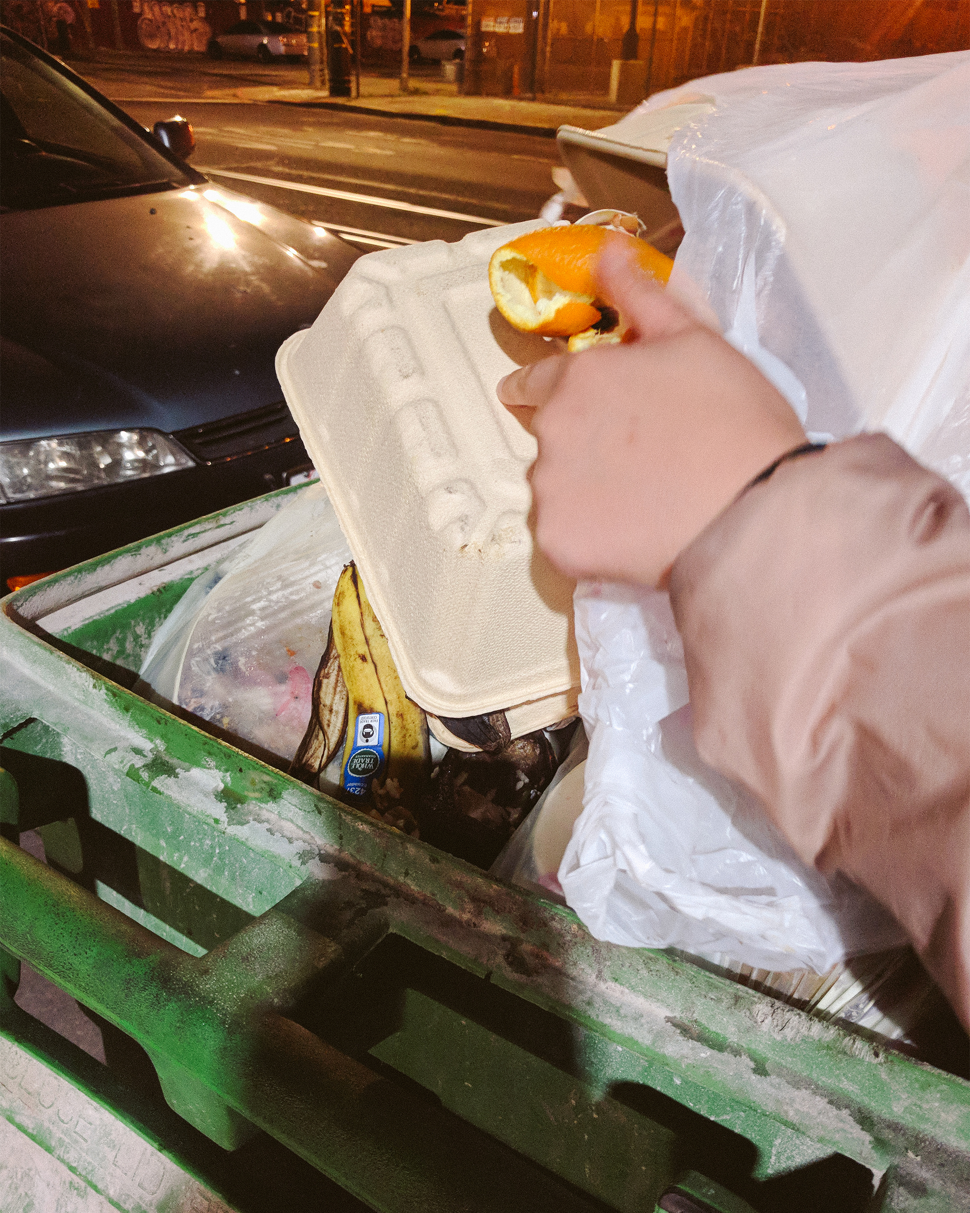 Photo of Vivian dumping food waste in compost bin